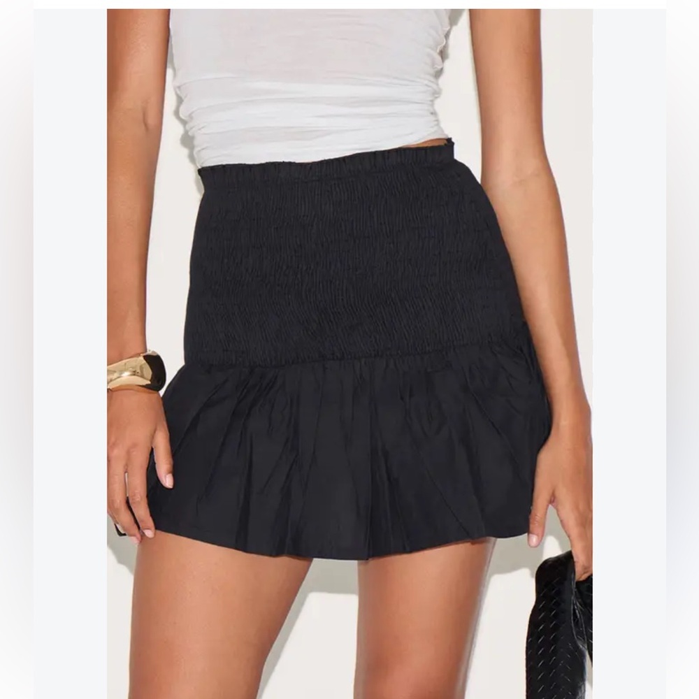 Endless Rose Black Smocked Ruffle Mini Skirt model wearing similar skort